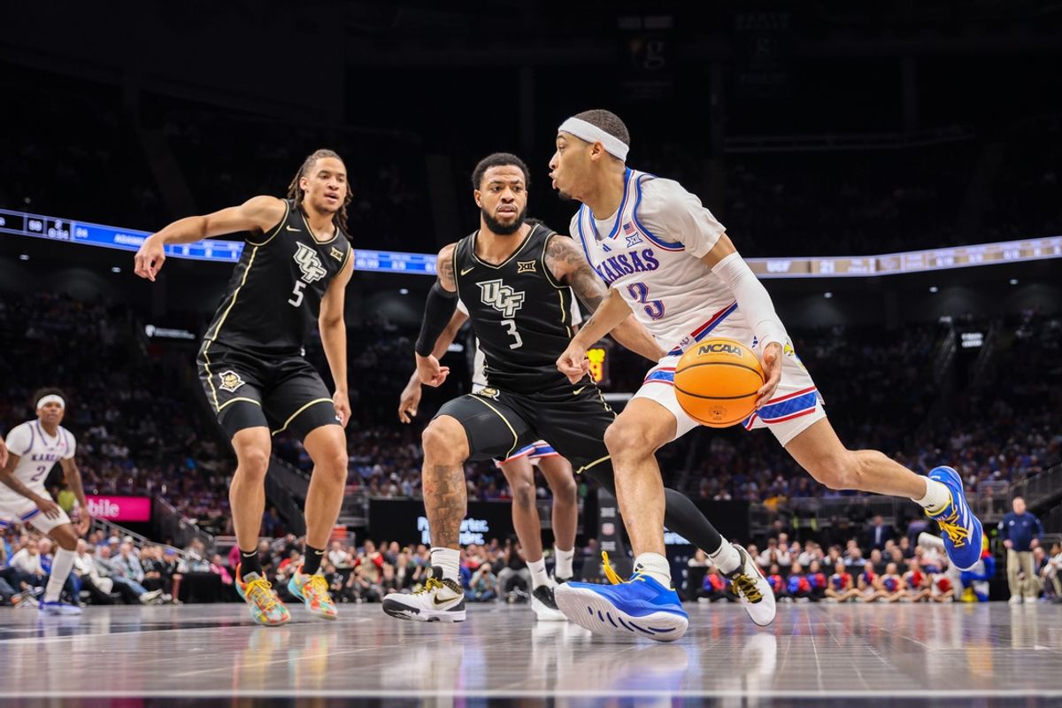 Mar 12, 2025; Kansas City, MO, USA; Kansas Jayhawks guard Dajuan Harris Jr. (3) drives to the basket during the first half against the UCF Knights at T-Mobile Center. Mandatory Credit: William Purnell-Imagn Images