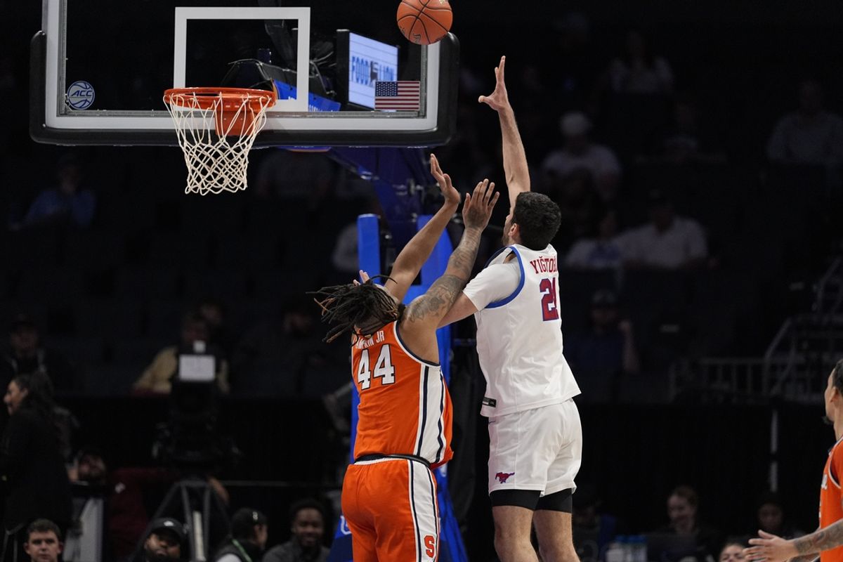 Mar 12, 2025; Charlotte, NC, USA; Southern Methodist Mustangs forward Yohan Traore (21) tries for a shot defended by Syracuse Orange center Eddie Lampkin Jr. (44) during the first half at Spectrum Center. Mandatory Credit: Jim Dedmon-Imagn Images