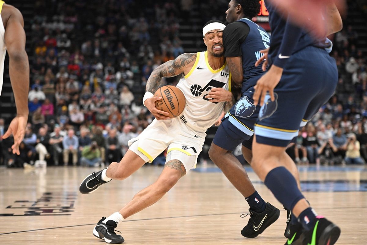 Mar 12, 2025; Memphis, Tennessee, USA; Utah Jazz power forward John Collins (20) drives into defender Memphis Grizzlies guard Vince Williams Jr. (5) in the fourth quarter at FedExForum. Mandatory Credit: Matthew Smith-Imagn Images