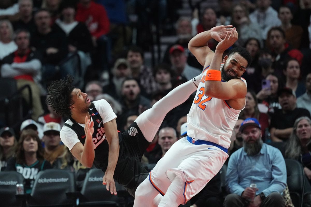 Mar 12, 2025; Portland, Oregon, USA; Portland Trail Blazers shooting guard Shaedon Sharpe (17) ommits an offensive foul against New York Knicks center Karl-Anthony Towns (32) during the second half at Moda Center. Mandatory Credit: Soobum Im-Imagn Images