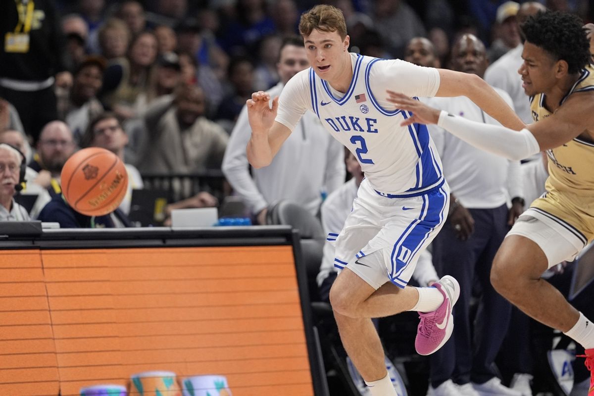 Mar 13, 2025; Charlotte, NC, USA;  Duke Blue Devils forward Cooper Flagg (2) and Georgia Tech Yellow Jackets guard Jaeden Mustaf (3) chase the loose ball during the first half at Spectrum Center. Mandatory Credit: Jim Dedmon-Imagn Images