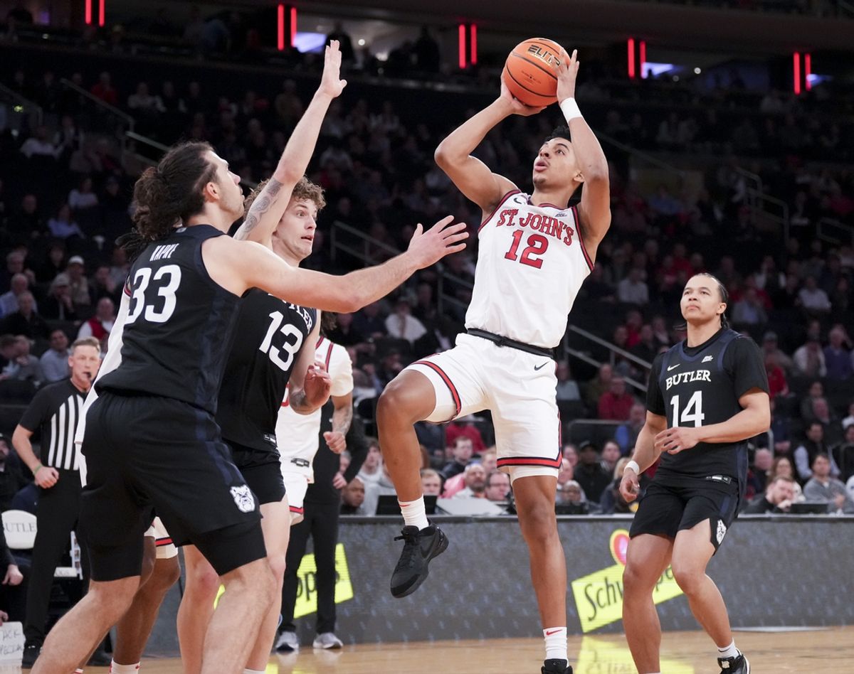 Mar 13, 2025; New York, NY, USA;  St. John's Red Storm guard RJ Luis Jr. (12) shoots past Butler Bulldogs during the first half at Madison Square Garden. Mandatory Credit: Robert Deutsch-Imagn Images