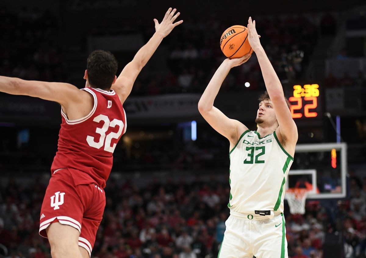 Mar 13, 2025; Indianapolis, IN, USA; Oregon Ducks center Nate Bittle (32) shoots over Indiana Hoosiers guard Trey Galloway (32) during the first half at Gainbridge Fieldhouse. Mandatory Credit: Robert Goddin-Imagn Images