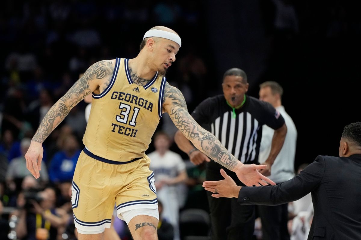 Mar 13, 2025; Charlotte, NC, USA; Georgia Tech Yellow Jackets forward Duncan Powell (31) reacts with head coach Damon Stoudamire after scoring in the first half at Spectrum Center. Mandatory Credit: Bob Donnan-Imagn Images