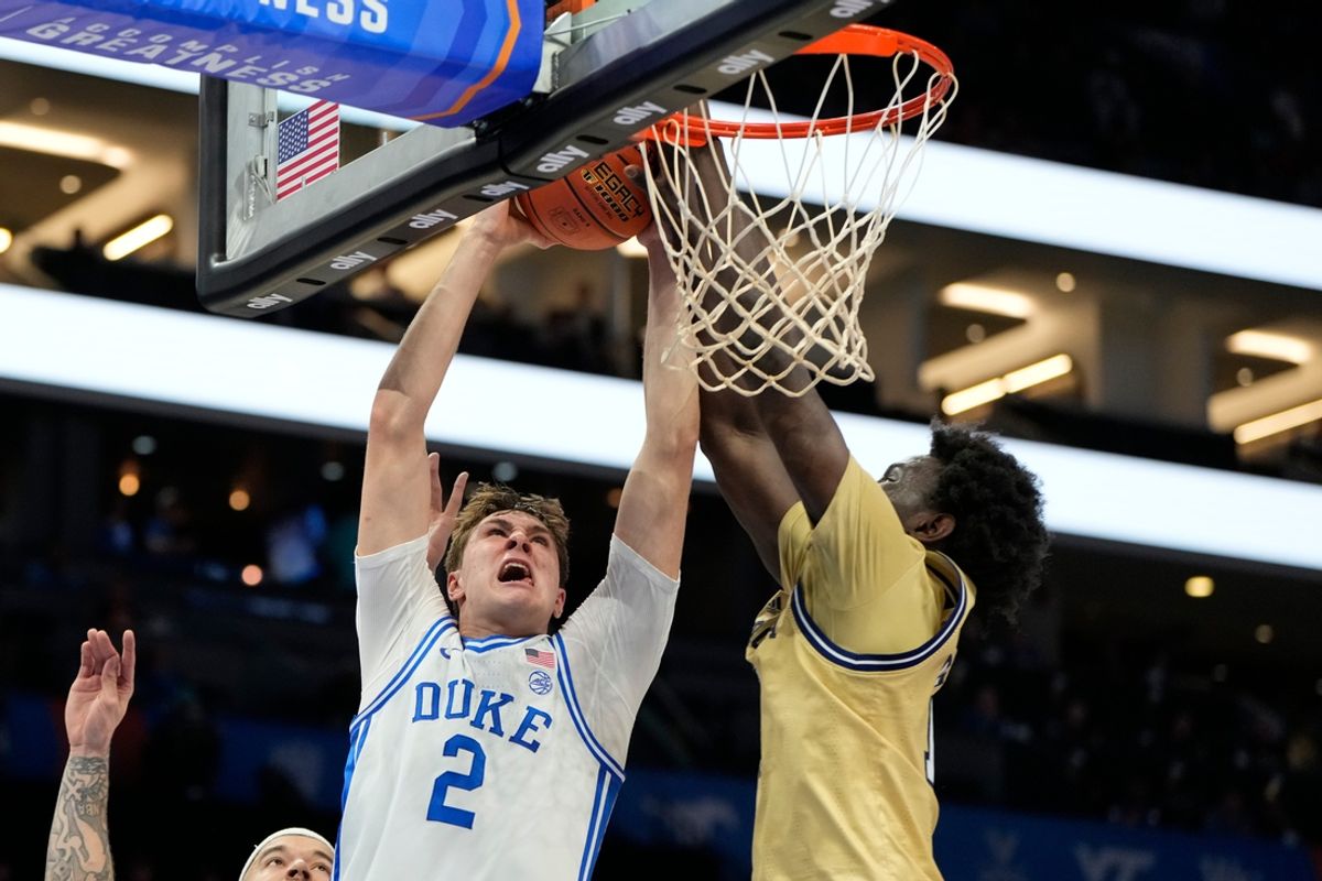 Mar 13, 2025; Charlotte, NC, USA; Duke Blue Devils forward Cooper Flagg (2) has his shot blocked by Georgia Tech Yellow Jackets forward Baye Ndongo (11) in the first half at Spectrum Center. Mandatory Credit: Bob Donnan-Imagn Images