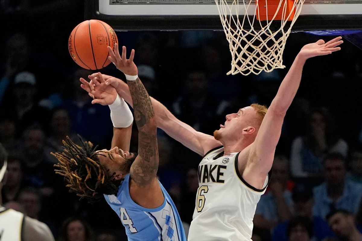 Mar 13, 2025; Charlotte, NC, USA; North Carolina Tar Heels guard RJ Davis (4) shoots as Wake Forest Demon Deacons guard Cameron Hildreth (6) defends in the first half at Spectrum Center. Mandatory Credit: Bob Donnan-Imagn Images