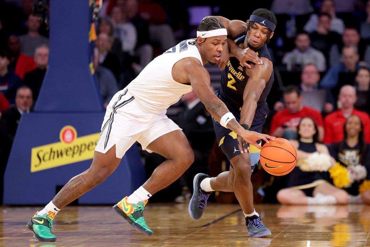 Mar 13, 2025; New York, NY, USA; Xavier Musketeers guard Ryan Conwell (7) fights for a loose ball against Marquette Golden Eagles guard Chase Ross (2) during the first half at Madison Square Garden. Mandatory Credit: Brad Penner-Imagn Images