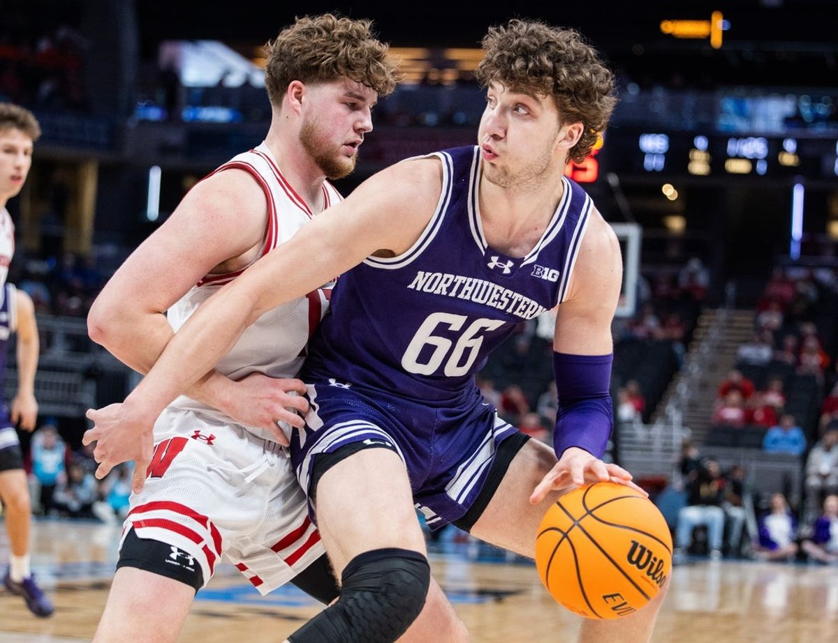 Mar 13, 2025; Indianapolis, IN, USA; Northwestern Wildcats forward Nick Martinelli (2) dribbles the ball while Wisconsin Badgers guard Max Klesmit (11) defends in the first half at Gainbridge Fieldhouse. Mandatory Credit: Trevor Ruszkowski-Imagn Images