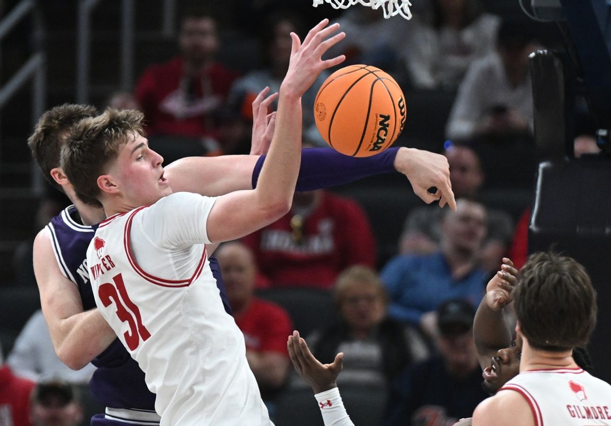 Mar 13, 2025; Indianapolis, IN, USA; Wisconsin Badgers forward Nolan Winter (31) and Northwestern Wildcats center Matthew Nicholson (34) look to rebound the ball during the first half at Gainbridge Fieldhouse. Mandatory Credit: Robert Goddin-Imagn Images
