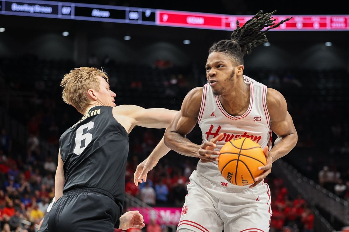 Mar 13, 2025; Kansas City, MO, USA; Houston Cougars forward Joseph Tugler (11) drives to the basket around Colorado Buffaloes forward Trevor Baskin (6) during the first half at T-Mobile Center. Mandatory Credit: William Purnell-Imagn Images