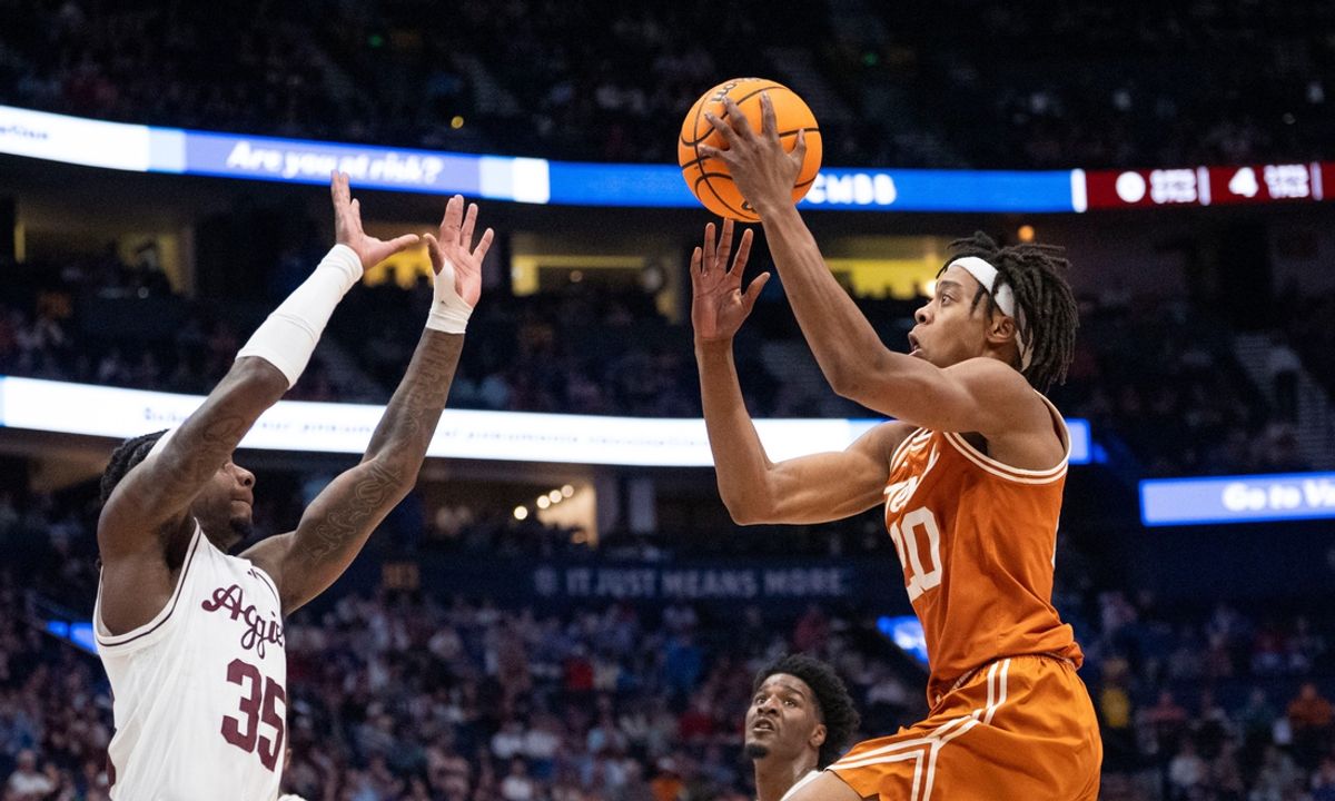Texas A&M Aggies guard Manny Obaseki (35) guards while Texas Longhorns guard Tre Johnson (20) goes up for a layup during their second round game of the SEC Men's Basketball Tournament at Bridgestone Arena in Nashville, Tenn., Thursday, March 13, 2025.