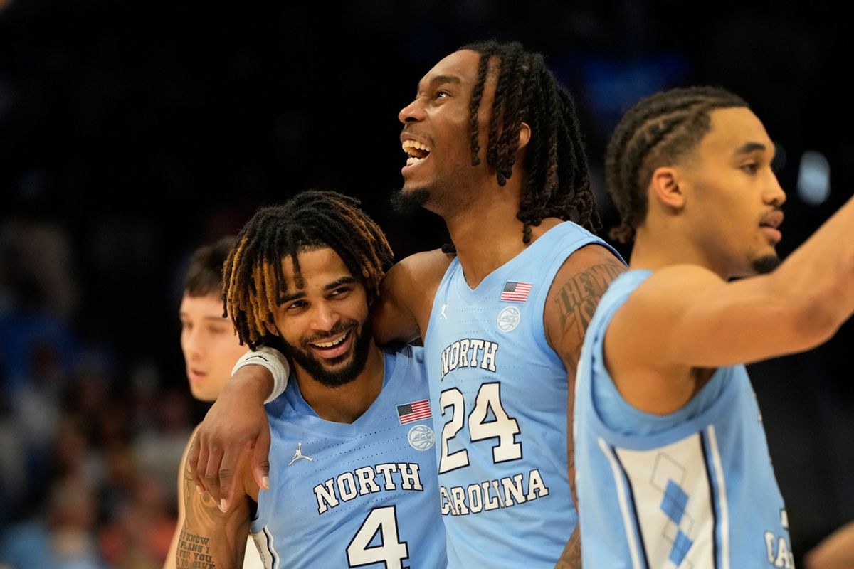 Mar 13, 2025; Charlotte, NC, USA; North Carolina Tar Heels guard RJ Davis (4) and forward Jae'Lyn Withers (24) and guard Seth Trimble (7) react near the end of the game at Spectrum Center. Mandatory Credit: Bob Donnan-Imagn Images