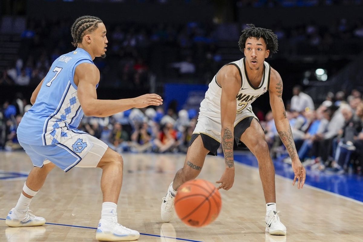 Mar 13, 2025; Charlotte, NC, USA; Wake Forest Demon Deacons guard Juke Harris (2) handles the ball against North Carolina Tar Heels guard Seth Trimble (7) during the second half at Spectrum Center. Mandatory Credit: Jim Dedmon-Imagn Images