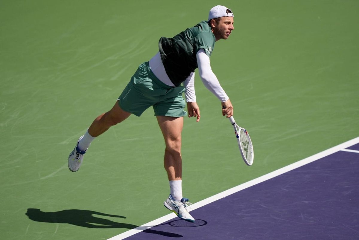 Tallon Griekspoor follows through on a serve to Holger Rune in their quarterfinal match on Stadium 2 at the BNP Paribas Open in Indian Wells, Calif., on Thurs., March 13, 2025.