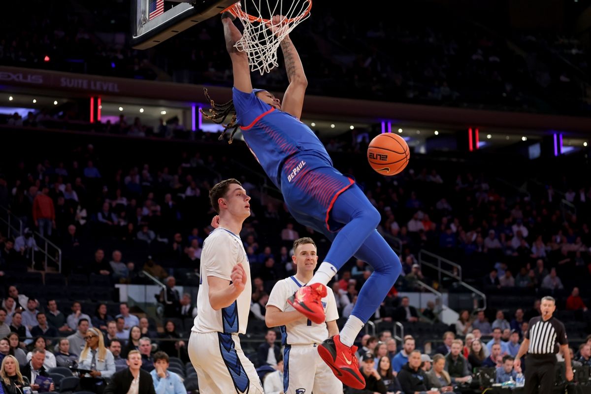Mar 13, 2025; New York, NY, USA; DePaul Blue Demons forward NJ Benson (35) hangs on the rim after a dunk against Creighton Bluejays center Ryan Kalkbrenner (11) and guard Steven Ashworth (1) during the first half at Madison Square Garden. Mandatory Credit: Brad Penner-Imagn Images