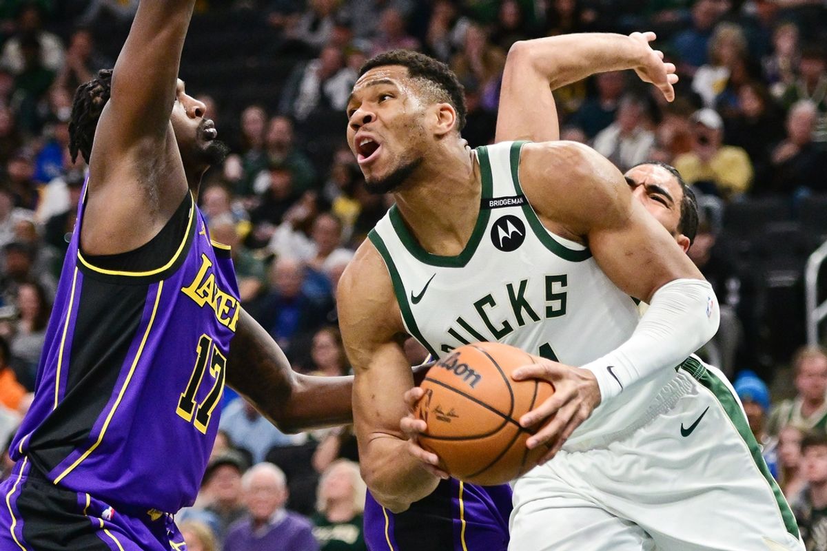 Mar 13, 2025; Milwaukee, Wisconsin, USA; Milwaukee Bucks forward Giannis Antetokounmpo (34) drives against Los Angeles Lakers forward Dorian Finney-Smith (17) in the first quarter at Fiserv Forum. Mandatory Credit: Benny Sieu-Imagn Images