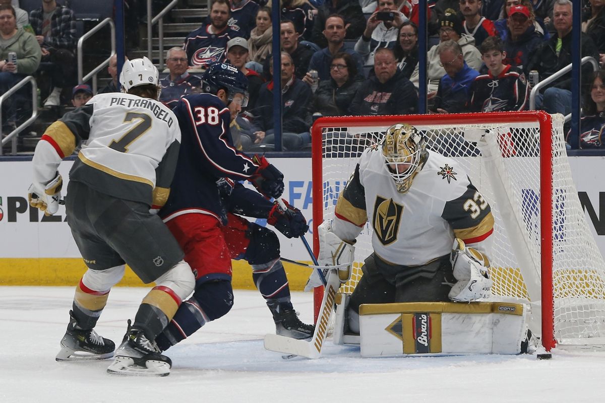 Mar 13, 2025; Columbus, Ohio, USA; Vegas Golden Knights goalie Adin Hill (33) makes a save on the shot from Columbus Blue Jackets center Boone Jenner (38) during the first period at Nationwide Arena. Mandatory Credit: Russell LaBounty-Imagn Images