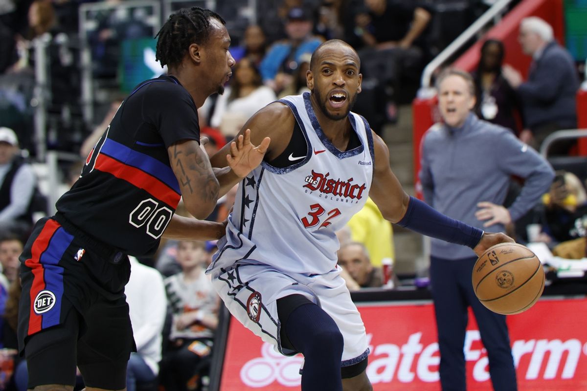 Mar 13, 2025; Detroit, Michigan, USA;  Washington Wizards forward Khris Middleton (32) dribbles defended by Detroit Pistons forward Ronald Holland II (00) in the first half at Little Caesars Arena. Mandatory Credit: Rick Osentoski-Imagn Images