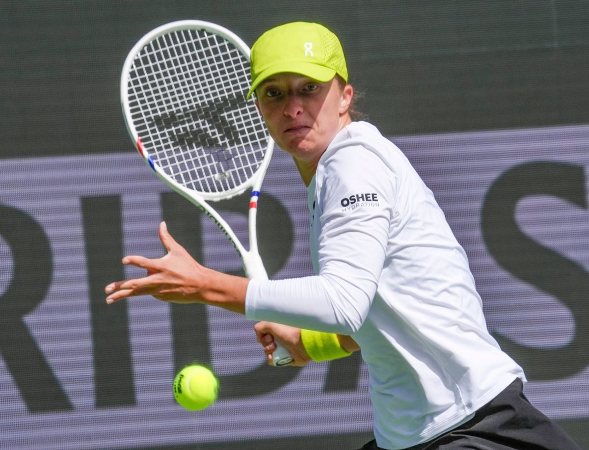Iga Swiatek hits a shot in her match against Qinwen Zheng at the Indian Wells Tennis Garden during the women’s quarterfinals at the BNP Paribas Open in Indian Wells, Calif., March 13, 2025.