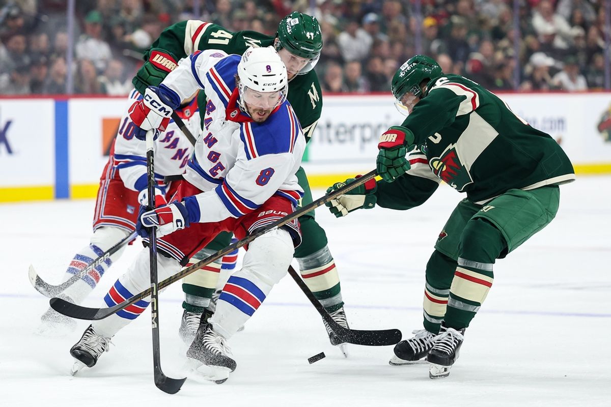 Mar 13, 2025; Saint Paul, Minnesota, USA; New York Rangers left wing J.T. Miller (8) and Minnesota Wild defenseman Jared Spurgeon (46) compete for the puck during the first period at Xcel Energy Center. Mandatory Credit: Matt Krohn-Imagn Images