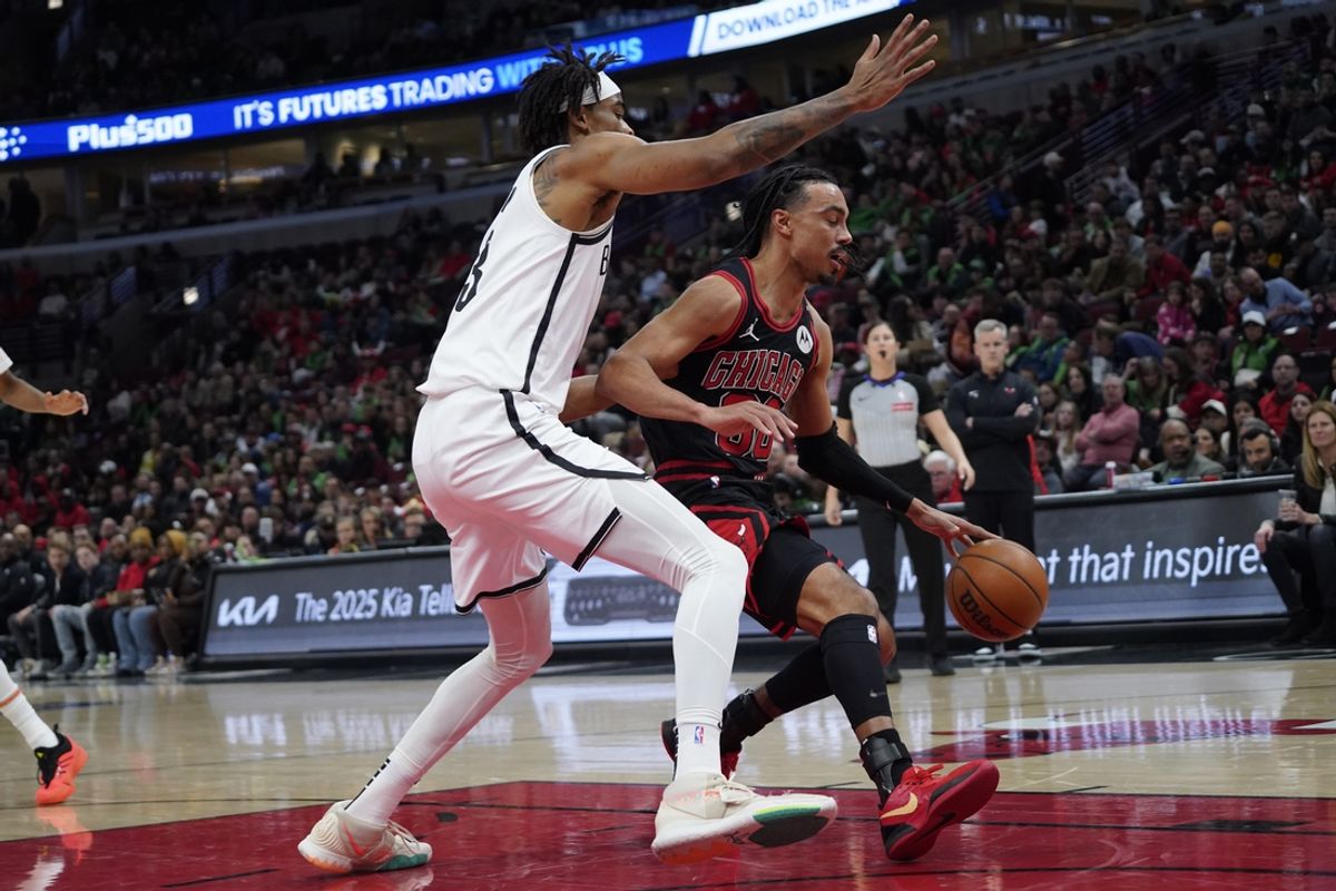 Mar 13, 2025; Chicago, Illinois, USA; Brooklyn Nets center Nic Claxton (33) defends Chicago Bulls guard Tre Jones (30) during the first quarter at United Center. Mandatory Credit: David Banks-Imagn Images
