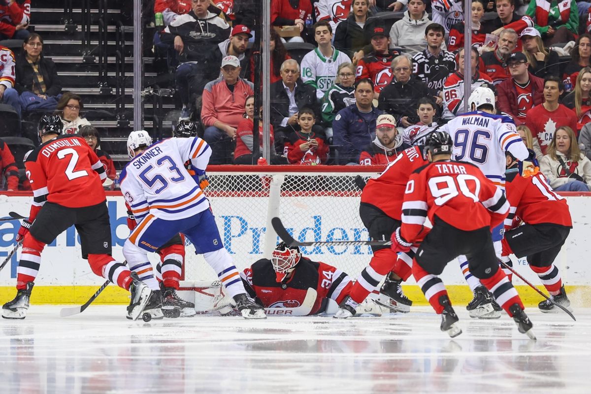 Mar 13, 2025; Newark, New Jersey, USA; New Jersey Devils goaltender Jake Allen (34) makes a save against the Edmonton Oilers during the second period at Prudential Center. Mandatory Credit: Ed Mulholland-Imagn Images