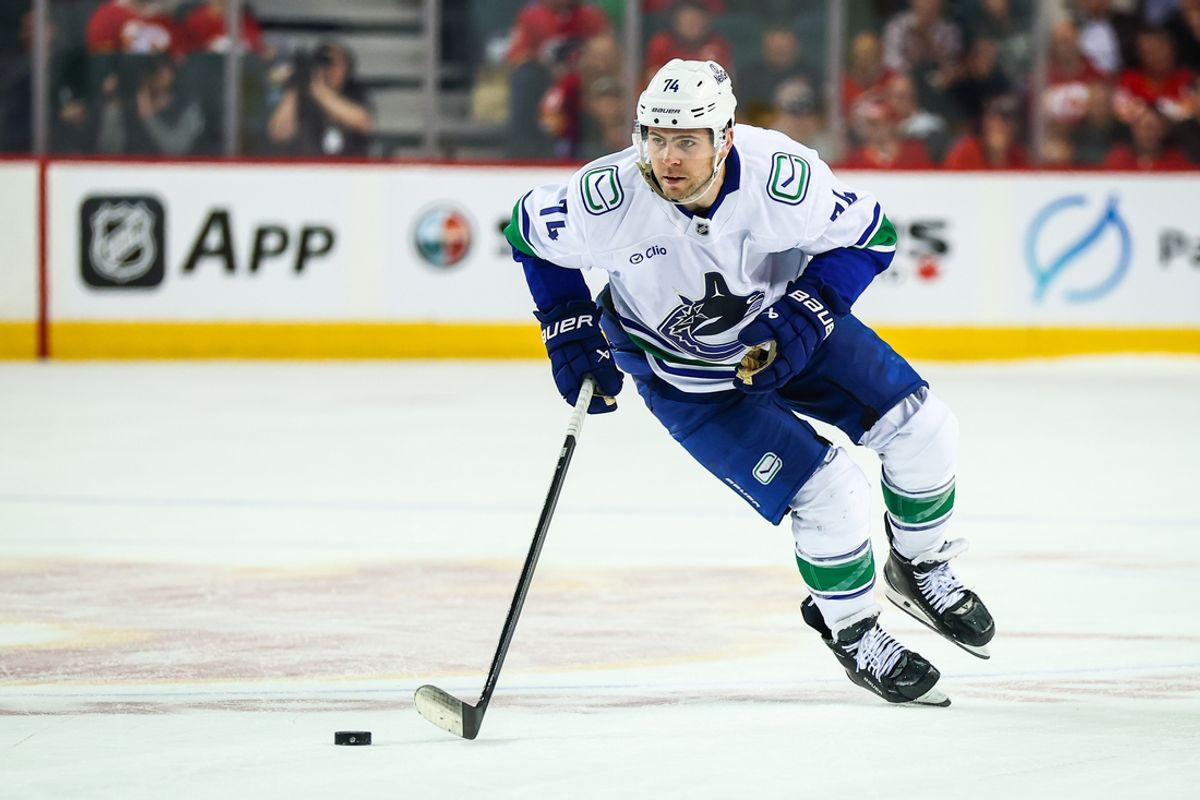 Mar 12, 2025; Calgary, Alberta, CAN; Vancouver Canucks left wing Jake DeBrusk (74) skates with the puck against the Calgary Flames during the shootout period at Scotiabank Saddledome. Mandatory Credit: Sergei Belski-Imagn Images