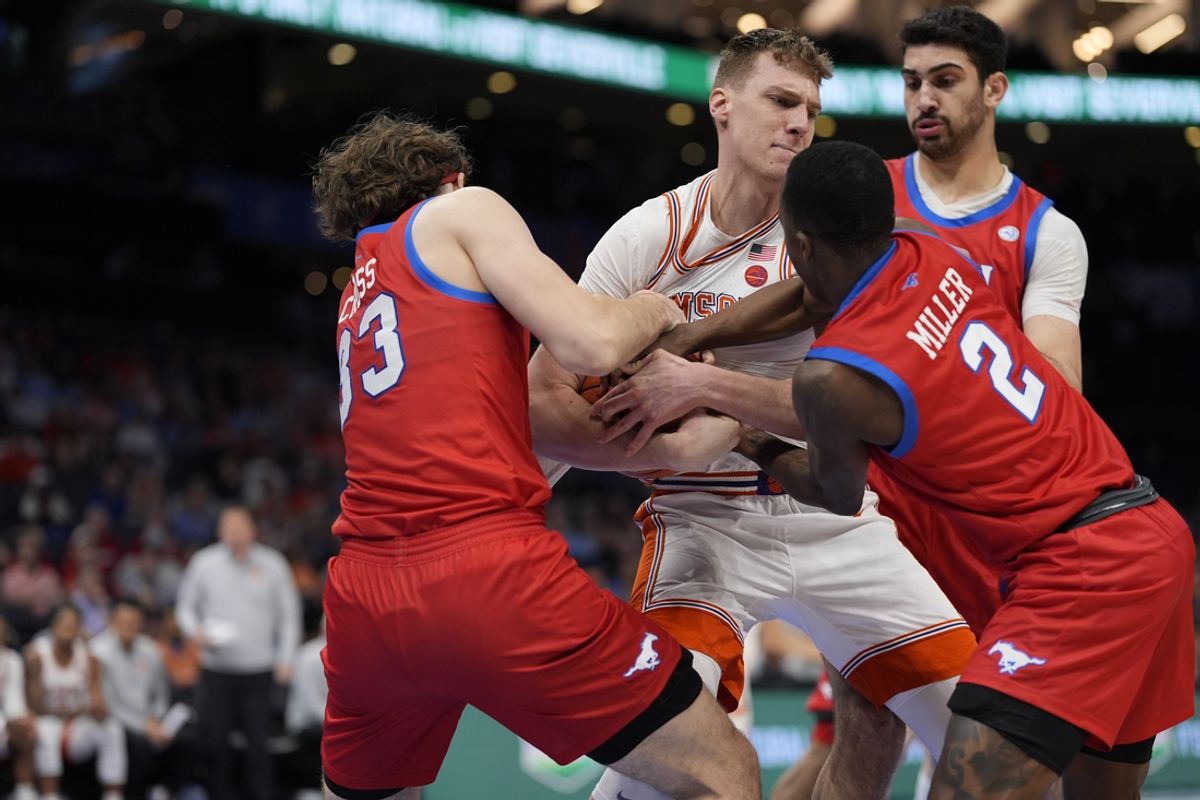 Mar 13, 2025; Charlotte, NC, USA; Clemson Tigers center Viktor Lakhin (0) tries to hold onto the ball despite the efforts of Southern Methodist Mustangs forward Matt Cross (33) and guard Boopie Miller (2) during the first half at Spectrum Center. Mandatory Credit: Jim Dedmon-Imagn Images