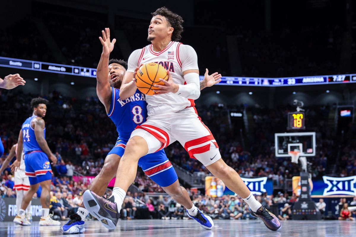 Mar 13, 2025; Kansas City, MO, USA; Arizona Wildcats forward Trey Townsend (4) drives to the basket around Kansas Jayhawks guard David Coit (8) during the first half at T-Mobile Center. Mandatory Credit: William Purnell-Imagn Images