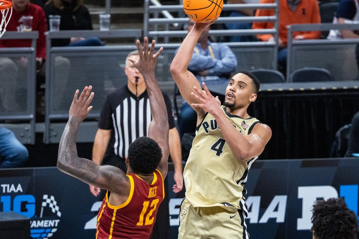 Mar 13, 2025; Indianapolis, IN, USA; Purdue Boilermakers forward Trey Kaufman-Renn (4) shoots the ball while USC Trojans forward Rashaun Agee (12) defends in the second half at Gainbridge Fieldhouse. Mandatory Credit: Trevor Ruszkowski-Imagn Images