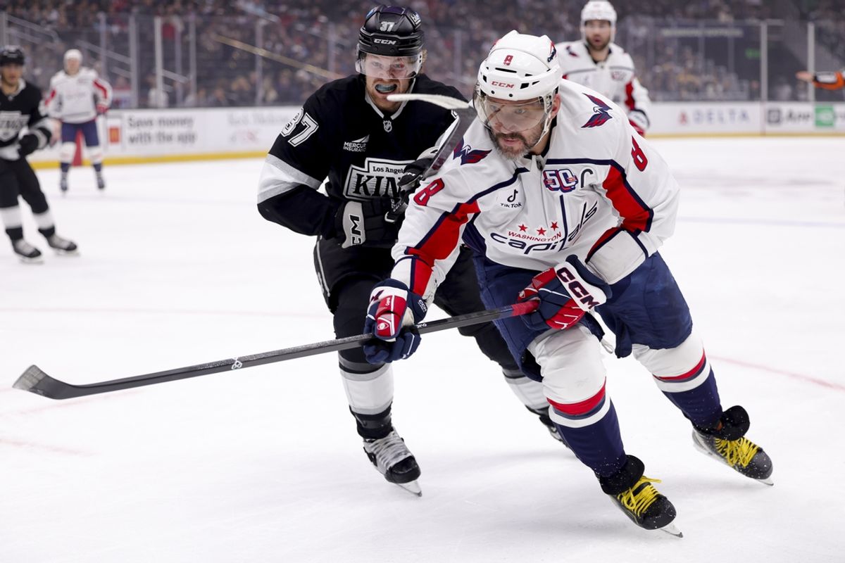 Mar 13, 2025; Los Angeles, California, USA; Washington Capitals left wing Alex Ovechkin (8) and Los Angeles Kings left wing Warren Foegele (37) chase the puck during the first period at Crypto.com Arena. Mandatory Credit: Ryan Sun-Imagn Images