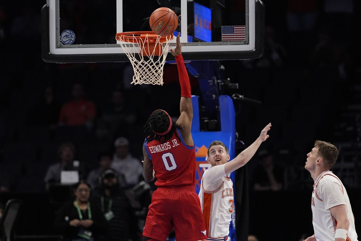 Mar 13, 2025; Charlotte, NC, USA; Southern Methodist Mustangs guard B.J. Edwards (0) goes up for a basket against Clemson Tigers guard Jake Heidbreder (3) during the second half at Spectrum Center. Mandatory Credit: Jim Dedmon-Imagn Images