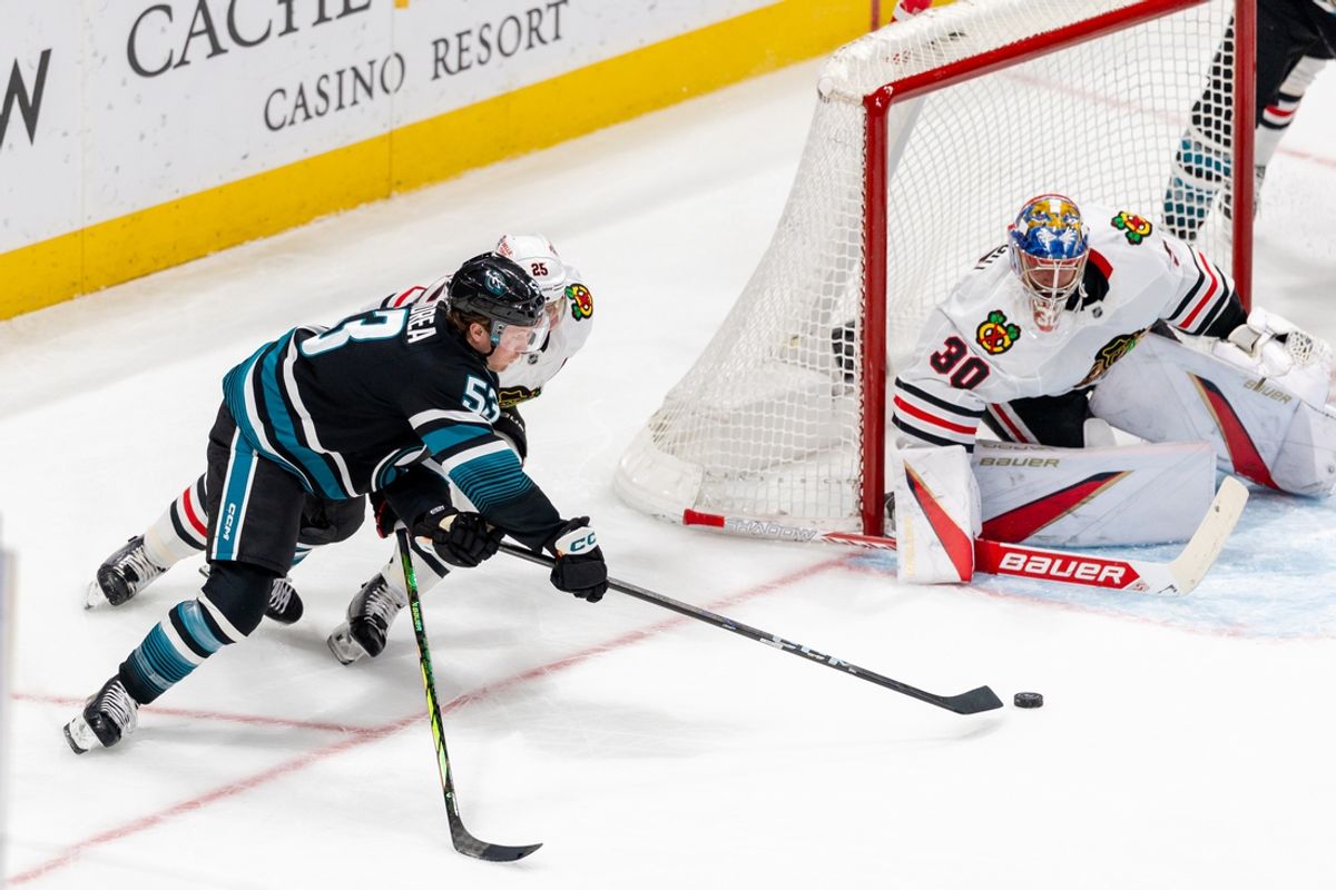 Mar 13, 2025; San Jose, California, USA; San Jose Sharks center Ty Dellandrea (53) attempts to slide the puck into the goal during the second period against the Chicago Blackhawks at SAP Center at San Jose. Mandatory Credit: Bob Kupbens-Imagn Images