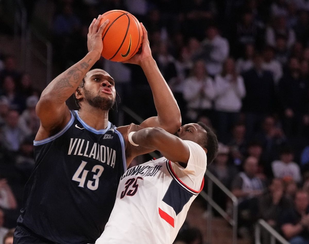 Mar 13, 2025; New York, NY, USA;  Villanova Wildcats forward Eric Dixon (43) shoots over Connecticut Huskies center Samson Johnson (35) during the second half at Madison Square Garden. Mandatory Credit: Robert Deutsch-Imagn Images