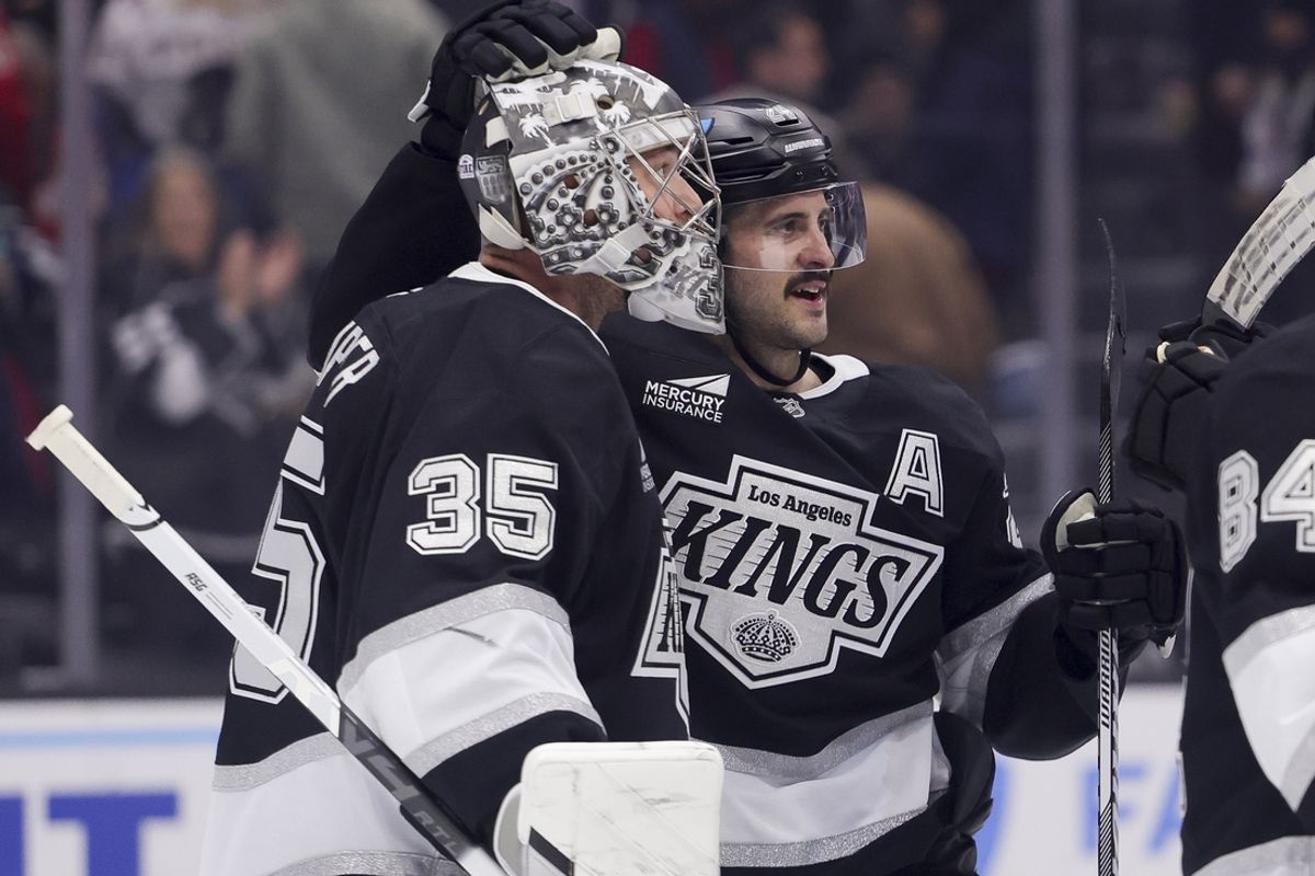 Mar 13, 2025; Los Angeles, California, USA; Los Angeles Kings goaltender Darcy Kuemper (35) and center Phillip Danault (24) celebrate after the team’s win against the Washington Capitals at Crypto.com Arena. Mandatory Credit: Ryan Sun-Imagn Images