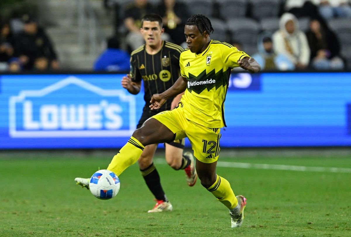 Mar 4, 2025; Los Angeles, California, USA;  Columbus Crew forward DeJuan Jones (12) controls the ball against Los Angeles FC defender Sergi Palencia (14) during the second half at BMO Stadium. Mandatory Credit: Alex Gallardo-Imagn Images