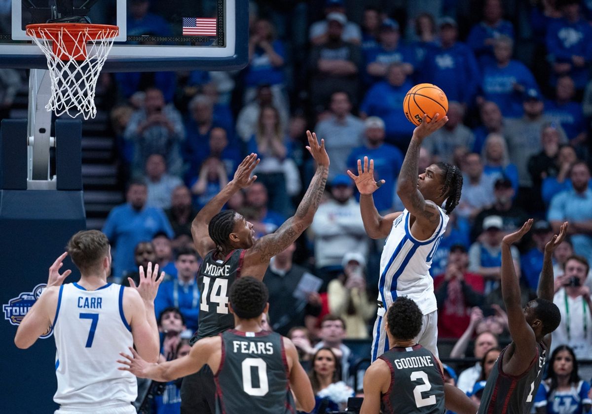 Kentucky Wildcats guard Otega Oweh (00) puts up the game-winning shot over Oklahoma Sooners forward Jalon Moore (14) as the clock wound down during their second round game of the SEC Men's Basketball Tournament at Bridgestone Arena in Nashville, Tenn., Thursday, March 13, 2025.