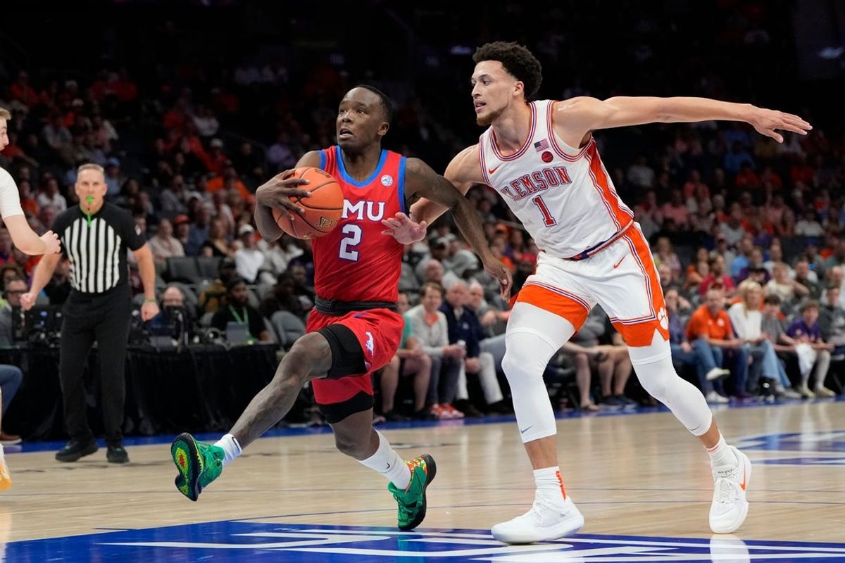 Mar 13, 2025; Charlotte, NC, USA; Southern Methodist Mustangs guard Boopie Miller (2) with the ball as Clemson Tigers guard Chase Hunter (1) defends in the second half at Spectrum Center. Mandatory Credit: Bob Donnan-Imagn Images