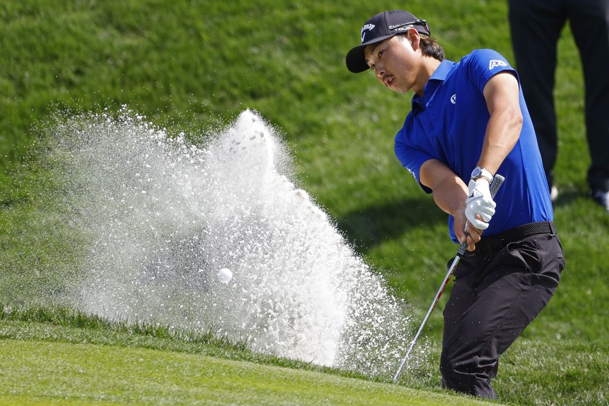 Mar 14, 2025; Ponte Vedra Beach, Florida, USA; Min Woo Lee hits out of the bunker to the ninth green during the second round of The Players Championship golf tournament at TPC Sawgrass. Mandatory Credit: Jeff Swinger-Imagn Images