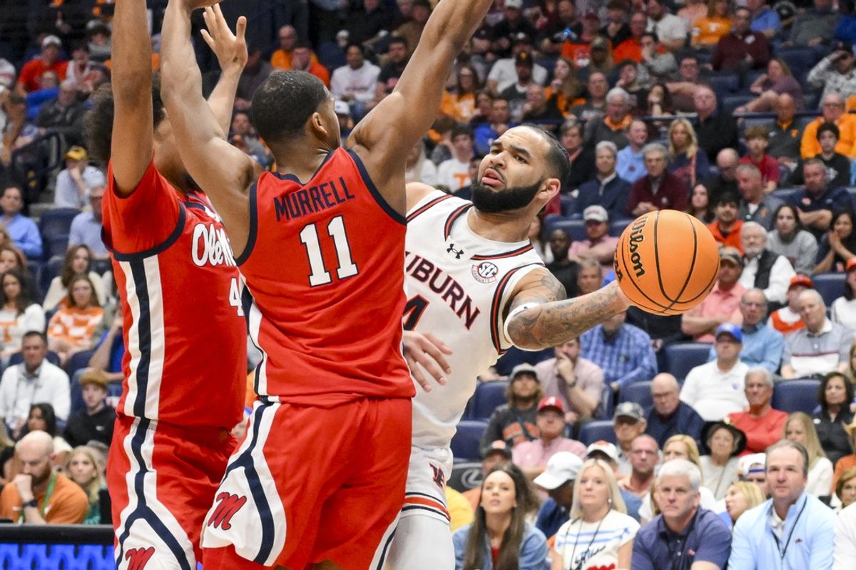 Mar 14, 2025; Nashville, TN, USA;  Auburn Tigers forward Johni Broome (4) passes the ball against the Mississippi Rebels during the first half at Bridgestone Arena. Mandatory Credit: Steve Roberts-Imagn Images
