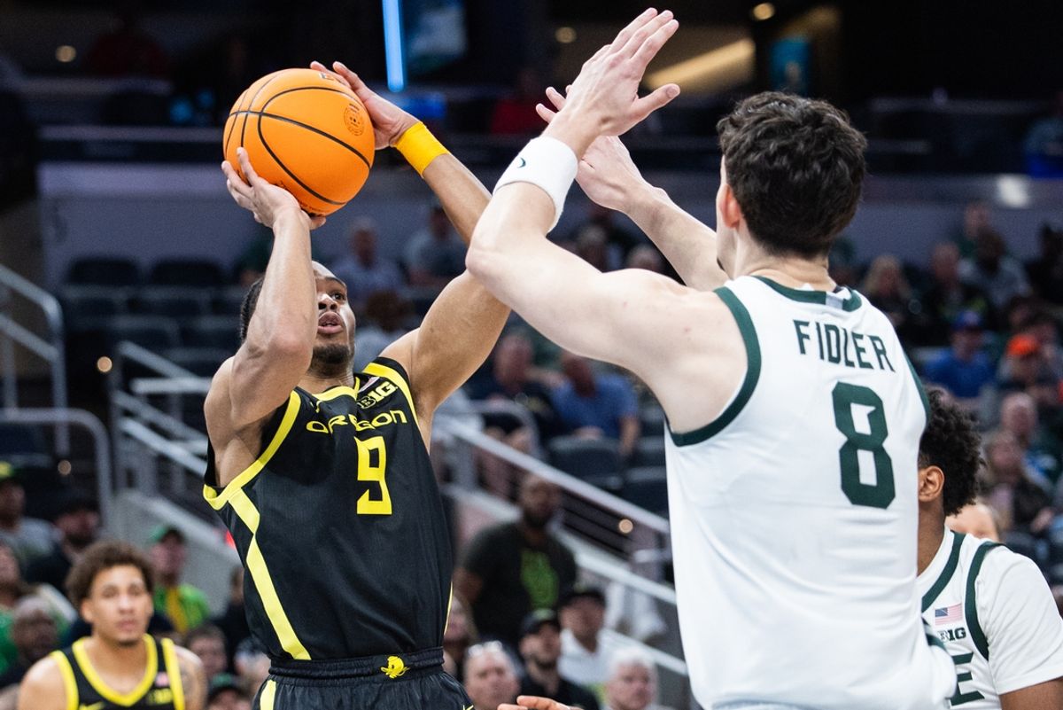 Mar 14, 2025; Indianapolis, IN, USA;  Oregon Ducks guard Keeshawn Barthelemy (9) shoots the ball whileMichigan State Spartans forward Frankie Fidler (8)  defends in the second half  at Gainbridge Fieldhouse. Mandatory Credit: Trevor Ruszkowski-Imagn Images