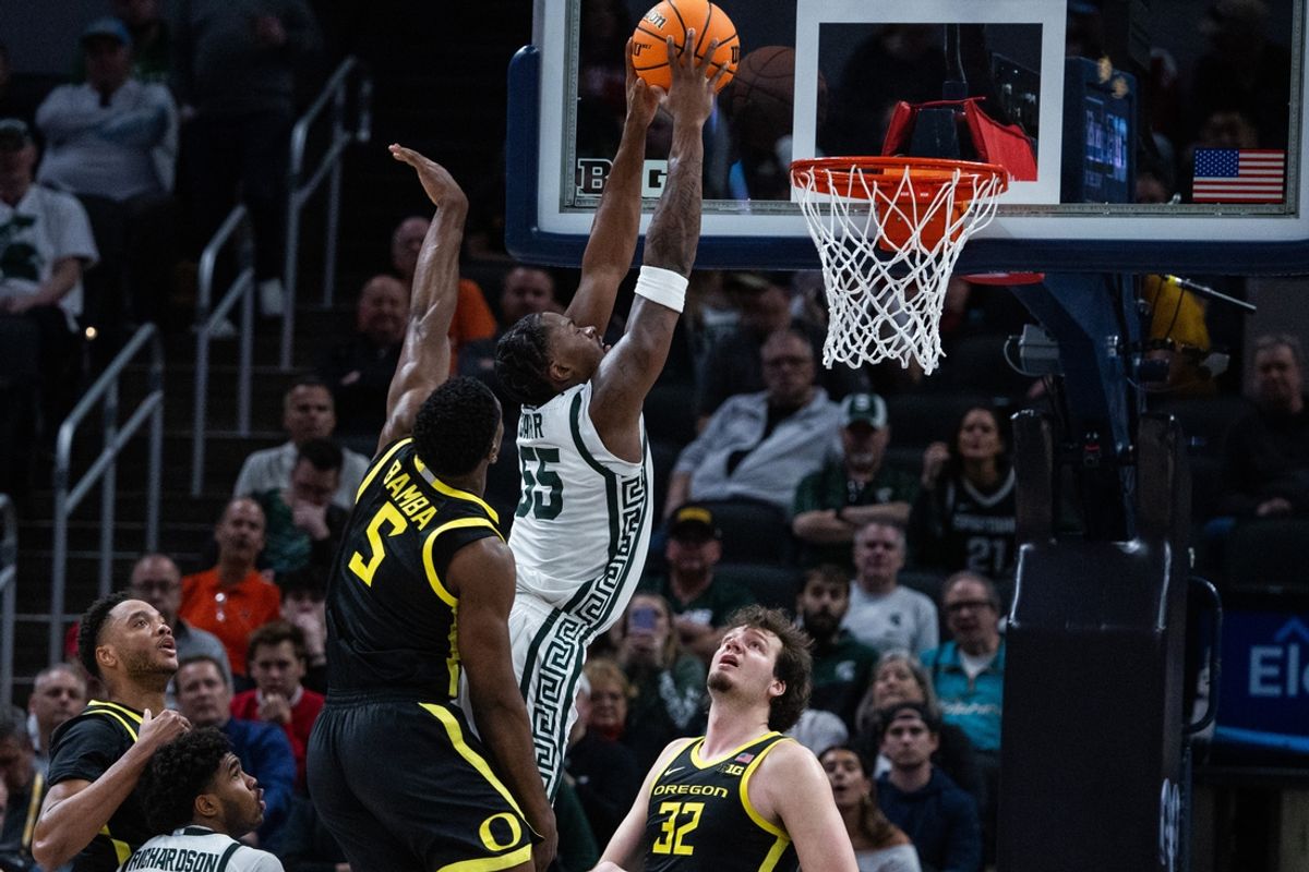 Mar 14, 2025; Indianapolis, IN, USA; Michigan State Spartans forward Coen Carr (55)  shoots the ball while  Oregon Ducks guard TJ Bamba (5) defends in the second half  at Gainbridge Fieldhouse. Mandatory Credit: Trevor Ruszkowski-Imagn Images