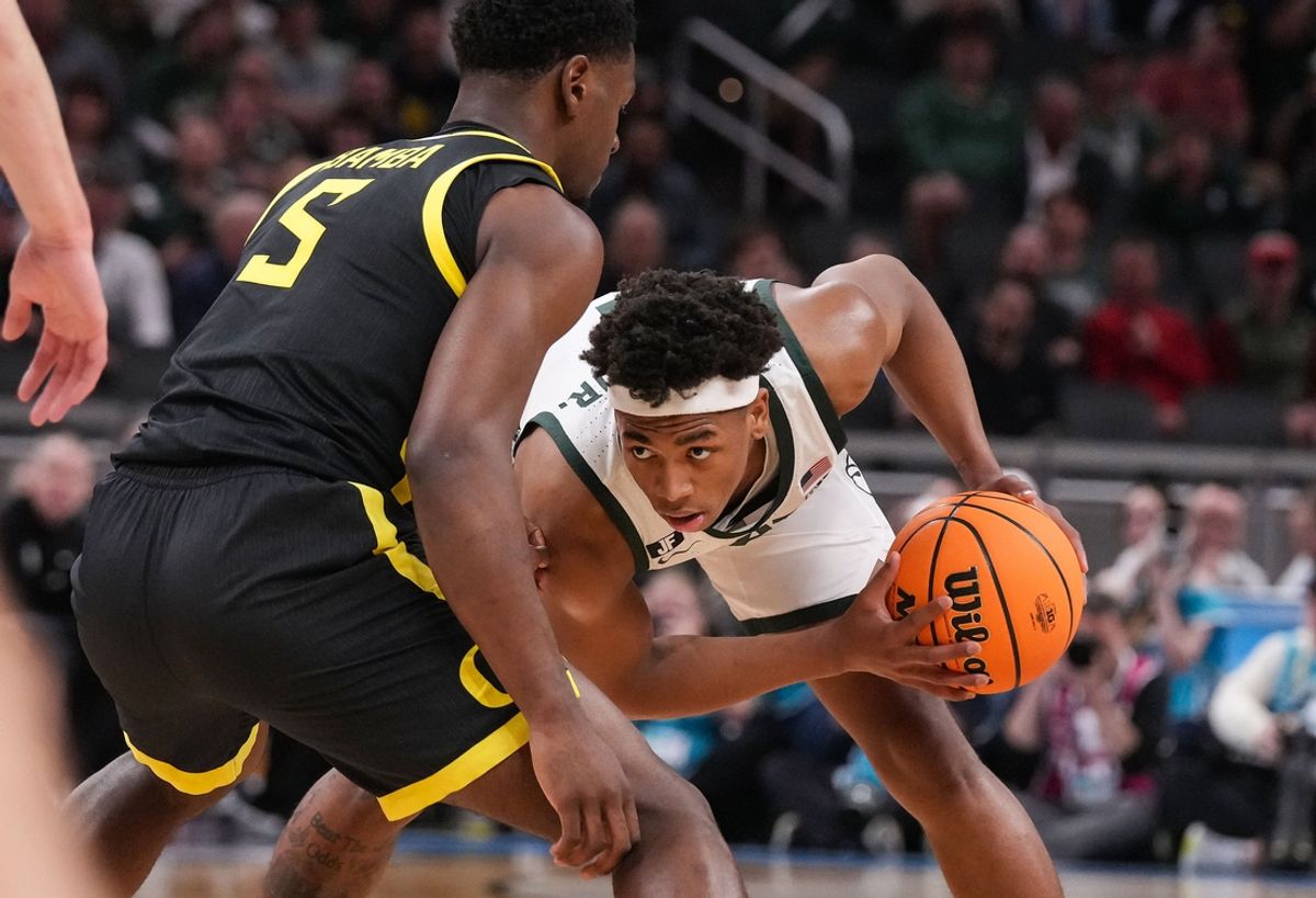 Michigan State Spartans guard Jaden Akins (3) searches to pass the ball against Oregon Ducks guard TJ Bamba (5) on Friday, March 14, 2025, during the third round of the men's Big Ten tournament at Gainbridge Fieldhouse in Indianapolis.