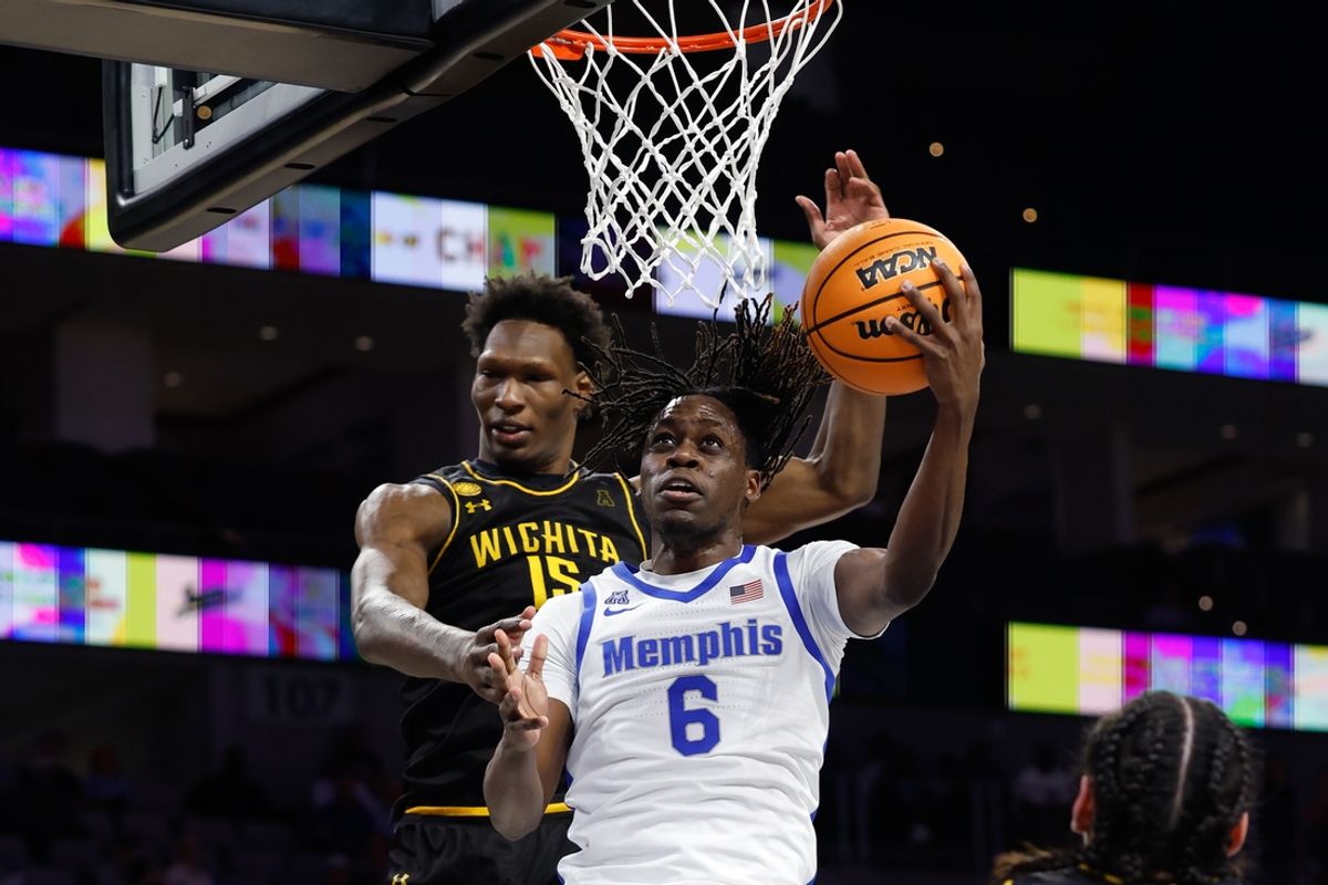 Mar 14, 2025; Fort Worth, TX, USA; Memphis Tigers guard Baraka Okojie (6) scores a layup against Wichita State Shockers center Quincy Ballard (15) during the second half at Dickies Arena. Mandatory Credit: Chris Jones-Imagn Images