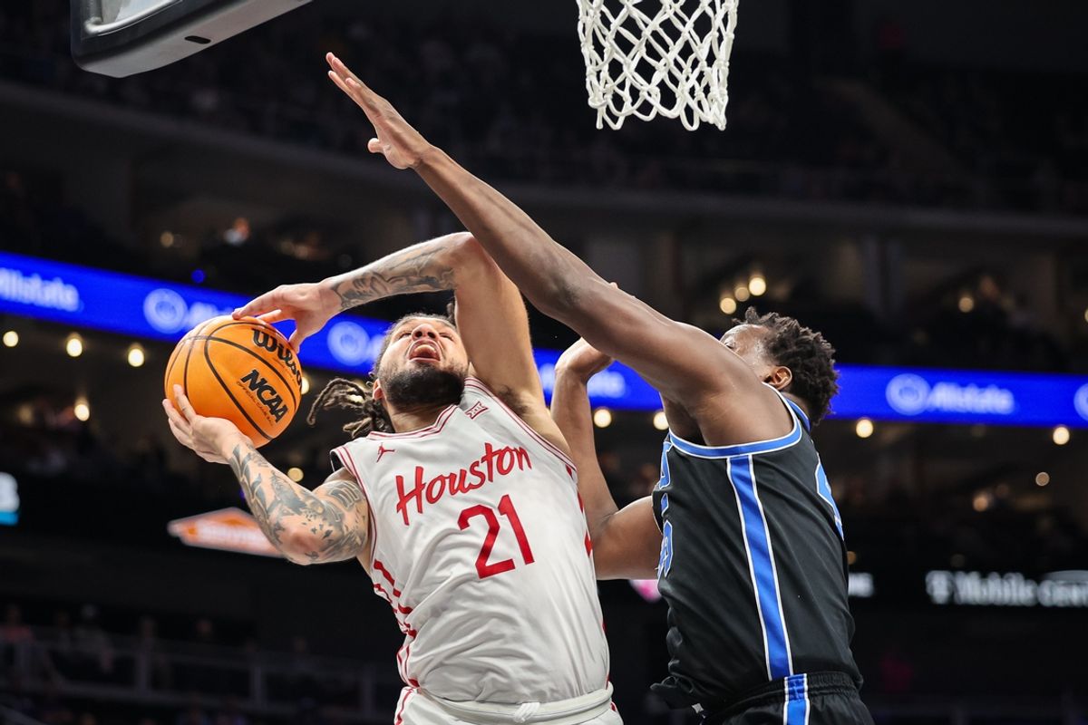 Mar 14, 2025; Kansas City, MO, USA; Houston Cougars guard Emanuel Sharp (21) shoots the ball around Brigham Young Cougars center Fousseyni Traore (45) during the first half at T-Mobile Center. Mandatory Credit: William Purnell-Imagn Images