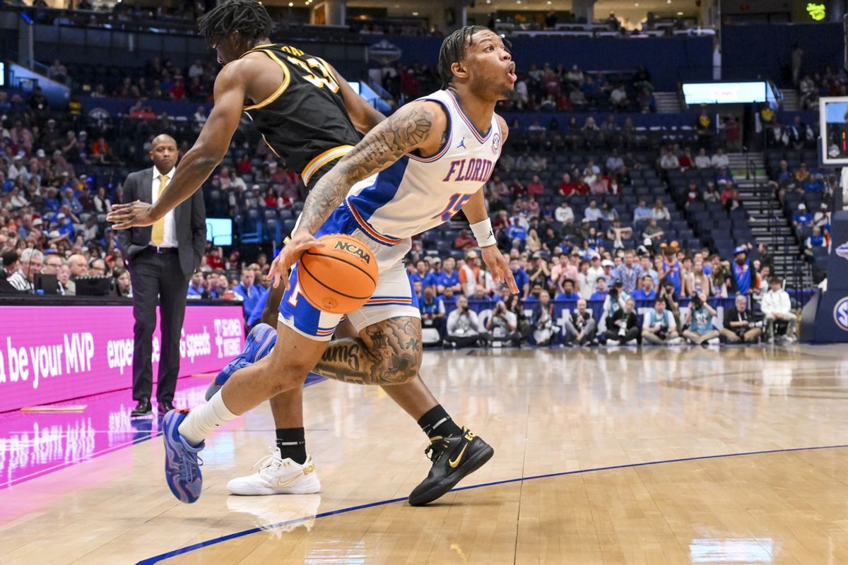 Mar 14, 2025; Nashville, TN, USA;  Florida Gators guard Alijah Martin (15) dribbles past Missouri Tigers center Josh Gray (33) during the first half at Bridgestone Arena. Mandatory Credit: Steve Roberts-Imagn Images