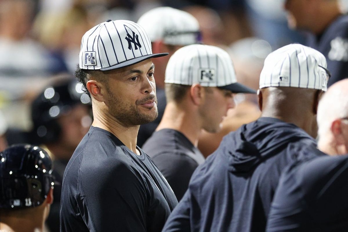 Mar 14, 2025; Tampa, Florida, USA; New York Yankees designated hitter Giancarlo Stanton (27) looks on from the dugout against the Philadelphia Phillies in the sixth inning during spring training at George M. Steinbrenner Field. Mandatory Credit: Nathan Ray Seebeck-Imagn Images