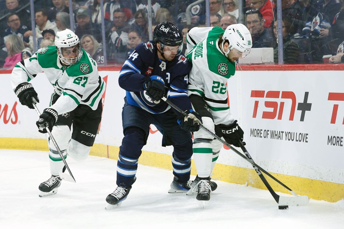 Mar 14, 2025; Winnipeg, Manitoba, CAN;  Winnipeg Jets defenseman Josh Morrissey (44) and Dallas Stars forward Mavrik Bourque battle for the puck during the second period at Canada Life Centre. Mandatory Credit: Terrence Lee-Imagn Images