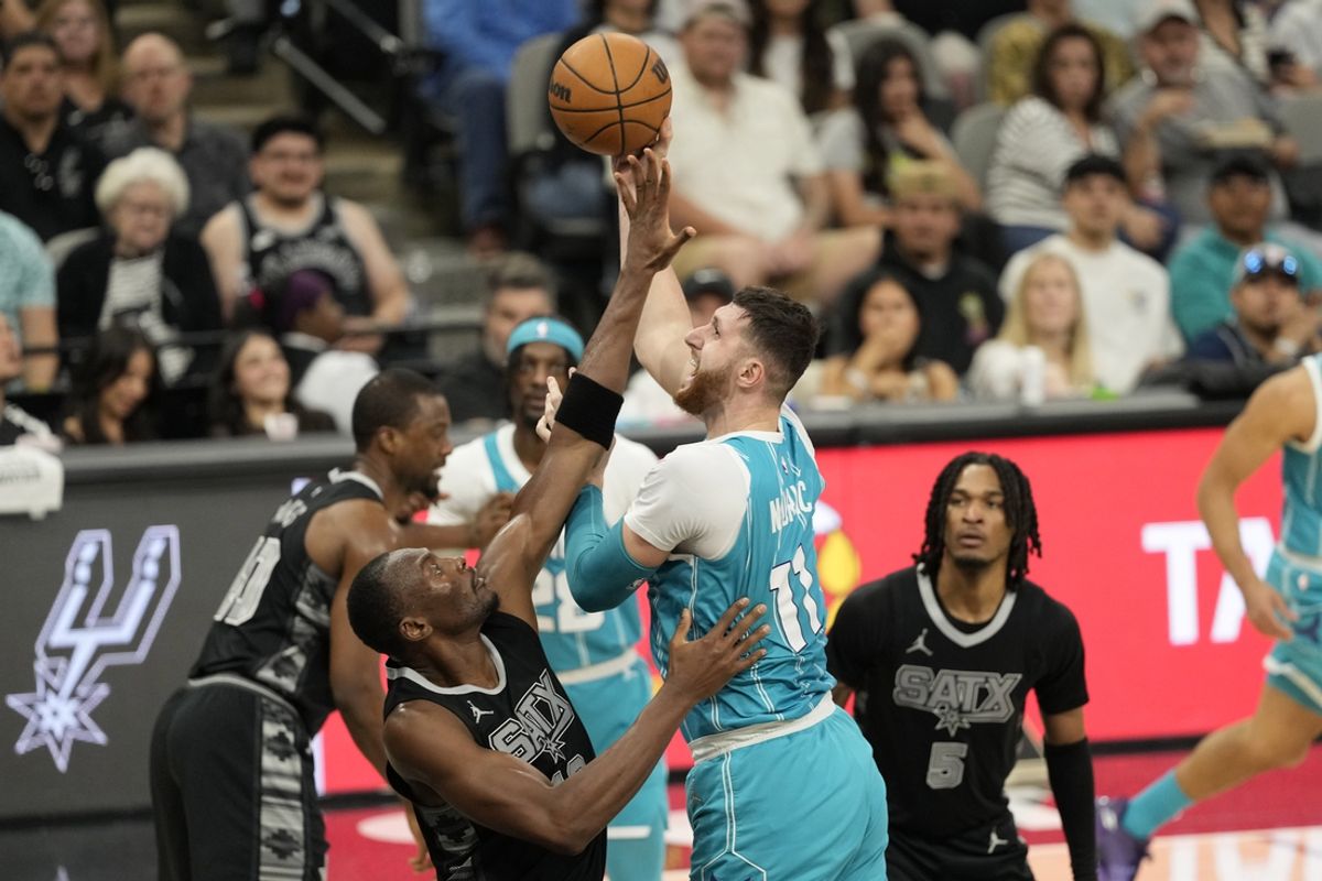 Mar 14, 2025; San Antonio, Texas, USA; Charlotte Hornets center Jusuf Nurkic (11) shoots over San Antonio Spurs center Bismack Biyombo (18) during the first half at Frost Bank Center. Mandatory Credit: Scott Wachter-Imagn Images