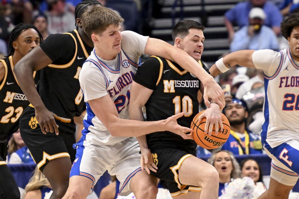 Mar 14, 2025; Nashville, TN, USA;  Florida Gators forward Alex Condon (21) grabs the ball from Missouri Tigers guard Jeremy Sanchez (10) during the second half at Bridgestone Arena. Mandatory Credit: Steve Roberts-Imagn Images